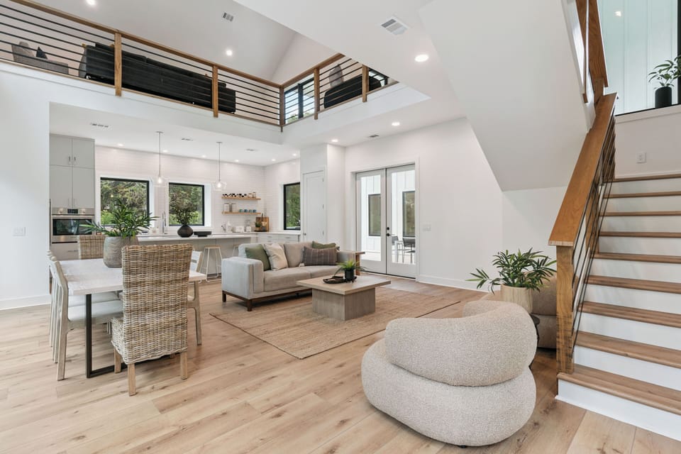 Step into this stunning open-concept space where soaring ceilings and natural light create an airy, welcoming atmosphere. You'll love the seamless flow from kitchen to dining to living areas—perfect for relaxing or entertaining.