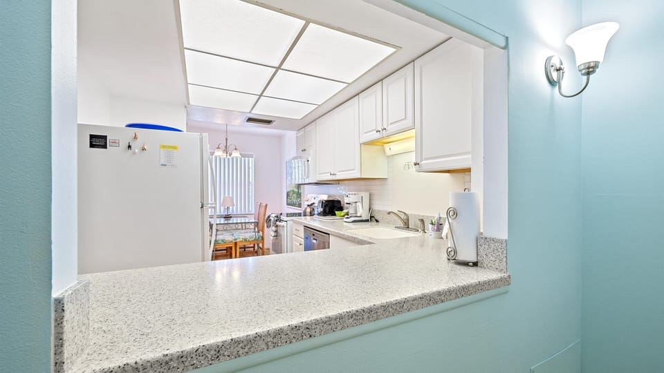 Your bright, fully-equipped kitchen welcomes you with white cabinetry, granite counters, and modern appliances. Enjoy meal prep in this cheerful space, where the open layout connects effortlessly to your dining area.