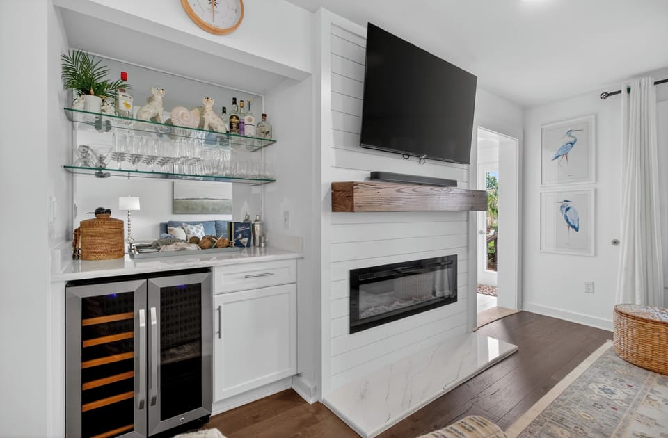Unwind in your bright living space with a cozy fireplace and wet bar for evening cocktails. Coastal artwork and modern touches make this the perfect retreat after beach adventures.
