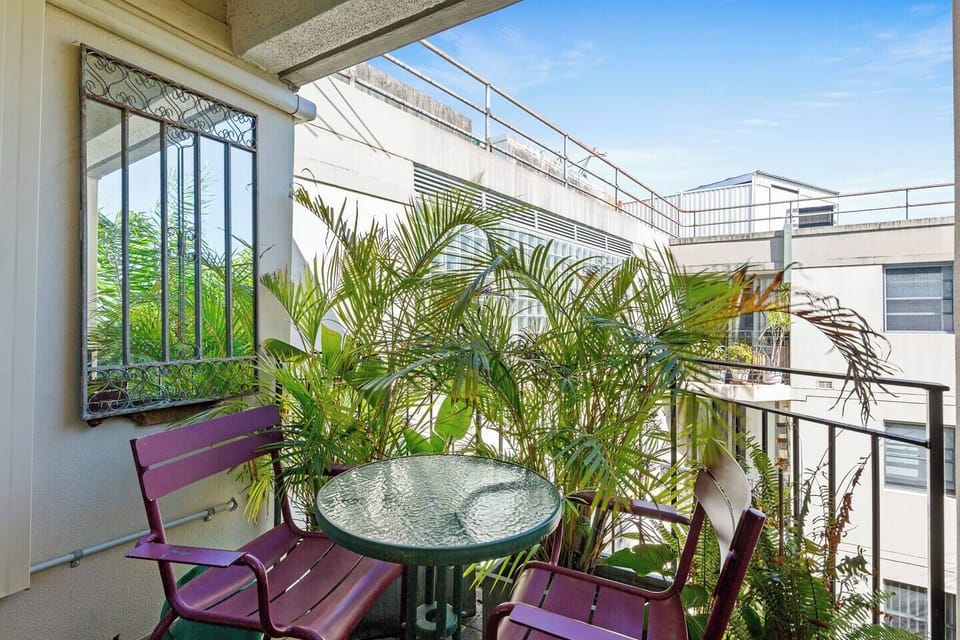 Enjoy a quiet coffee or evening drink on the private balcony, surrounded by leafy greenery.