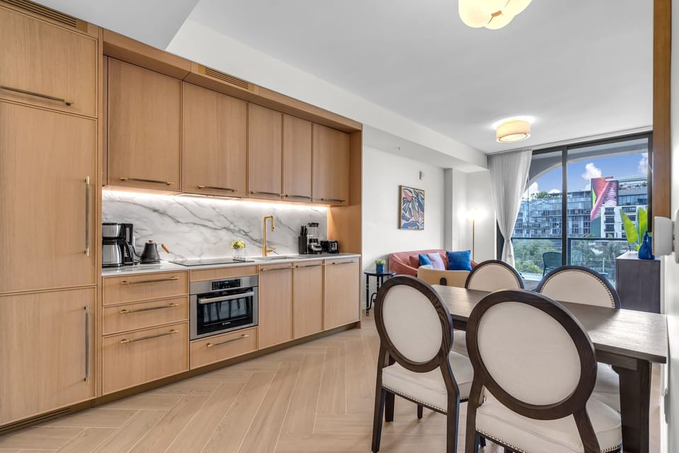 Elegant dining area with designer chairs and warm wood finishes — a sophisticated space to enjoy your meals together