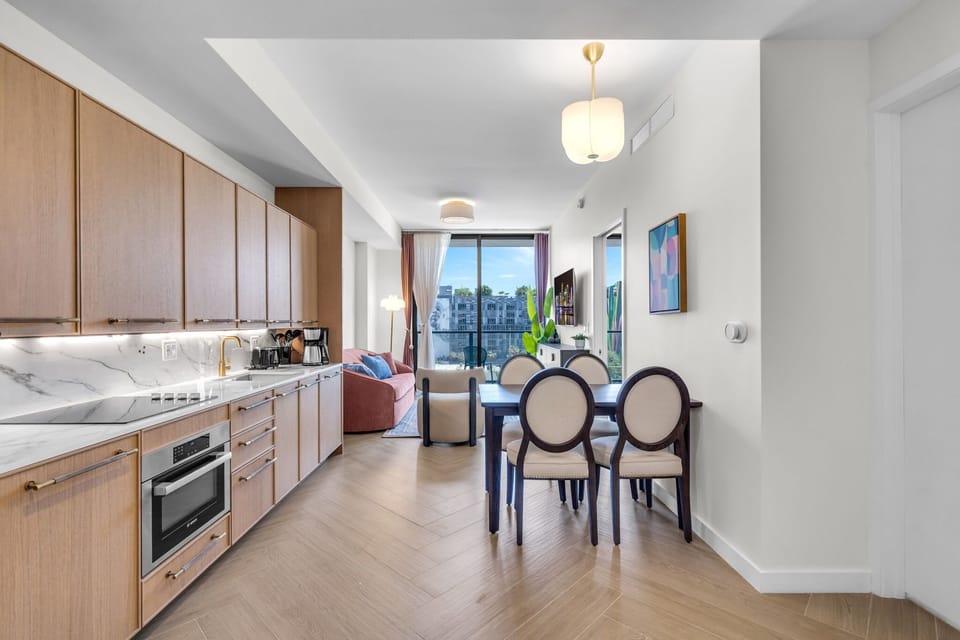 Elegant dining area with designer chairs and warm wood finishes — a sophisticated space to enjoy your meals together