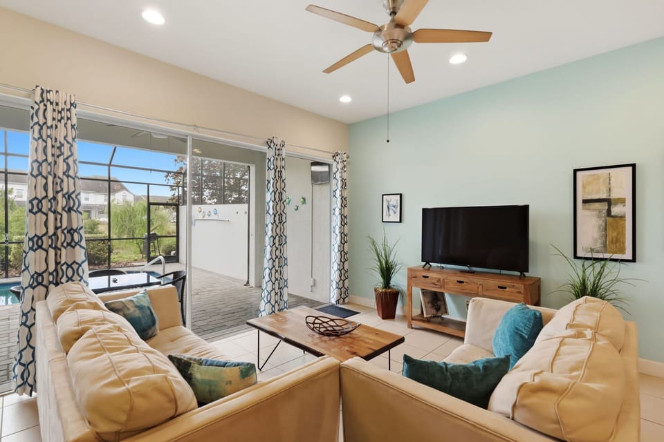 Comfortable living room with plenty of seating and relaxing pool views.