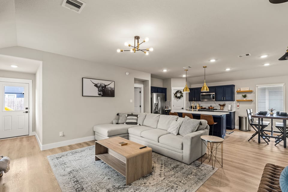 Open-concept living with a comfy couch and kitchen just steps away.