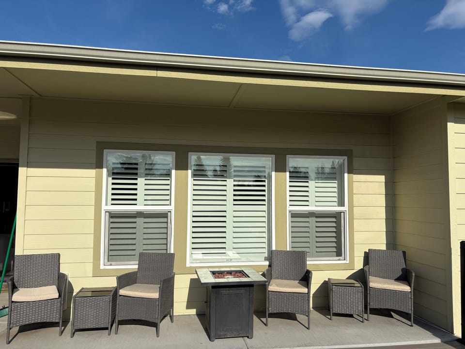 Rear patio includes ample seating, fire table, table for six, and propane BBQ.