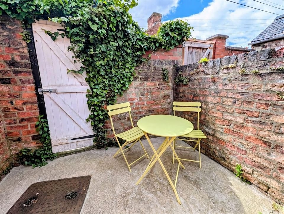 Charming private courtyard with ivy-covered walls and bistro seating