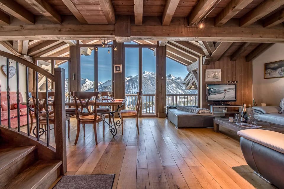 Spacious lounge area with mountain atmosphere, wooden details and comfortable seating for a cozy ski holiday.