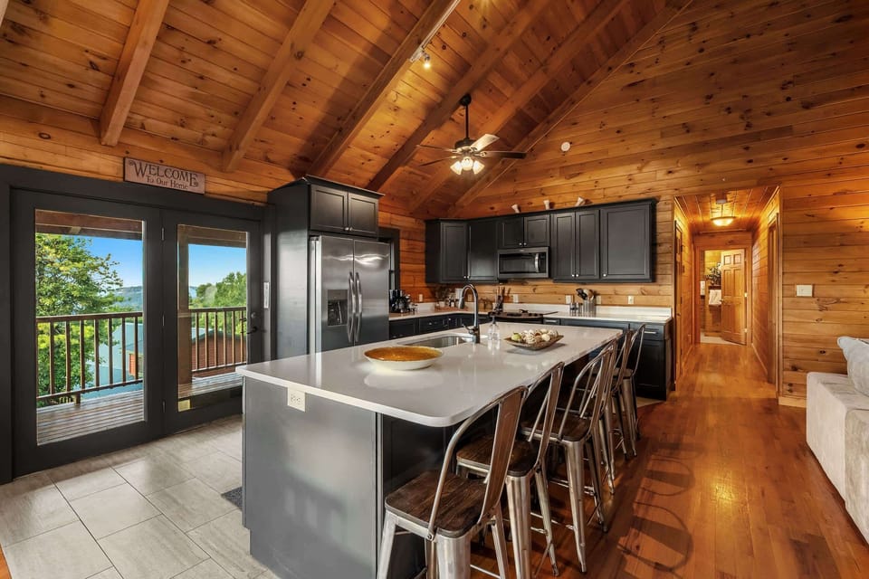A big granite island with bar seating anchors the kitchen — pull up a stool and stay a while.