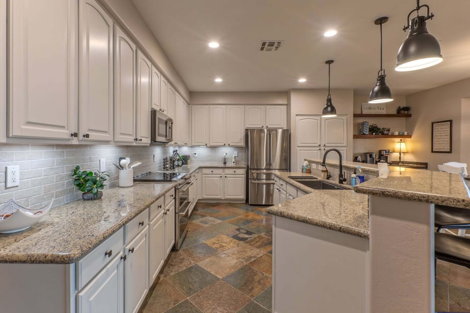 Kitchen is generous in size, well stocked and organized for prepping and serving home cooked meals.