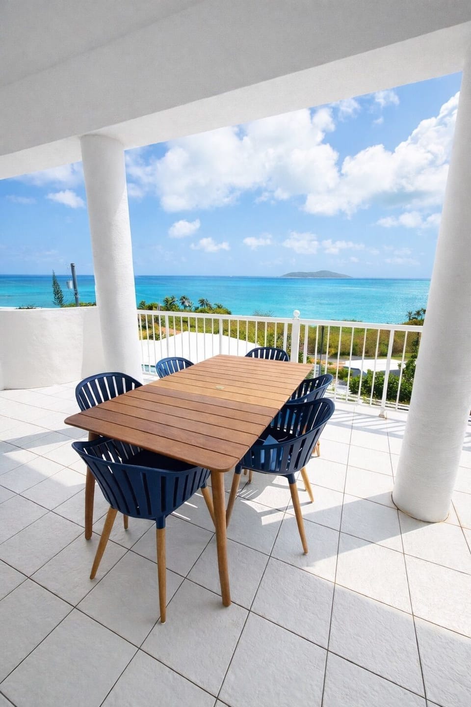 Veranda off the living room with dining table.