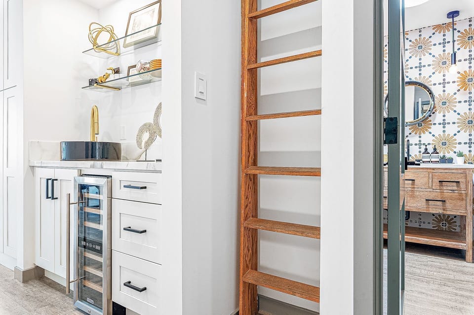 Wet bar with beverage fridge and added storage
                