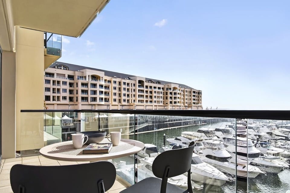 Balcony with front-row marina views & outdoor seating