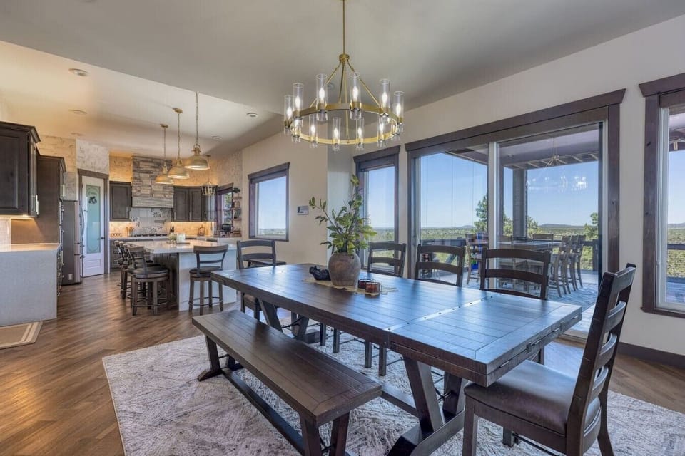 The open-concept layout seamlessly connects the gourmet kitchen and dining area, all framed by breathtaking views.