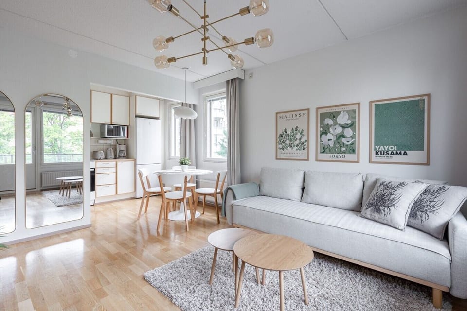 Relax in a beautifully lit living space designed with Scandinavian elegance. The large windows look out onto the peaceful neighborhood, bringing the outdoors in.