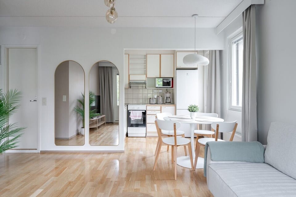 Our living space seamlessly flows into the dining and kitchen areas. The elegant arched mirrors enhance the room`s airy and spacious feel.