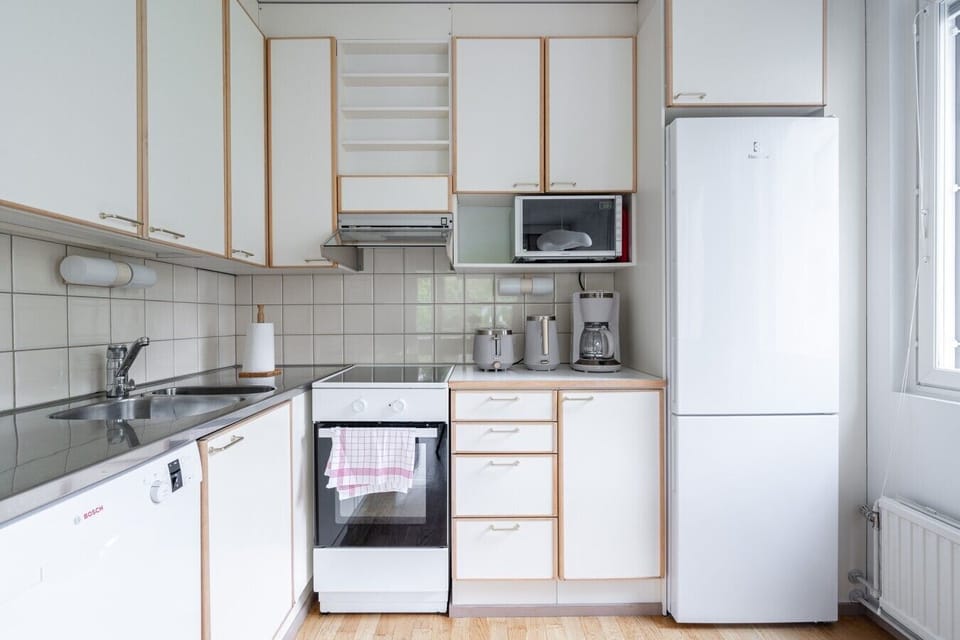 Cook your favorite meals in our clean, fully equipped kitchen featuring all essential appliances and a cozy dining corner.