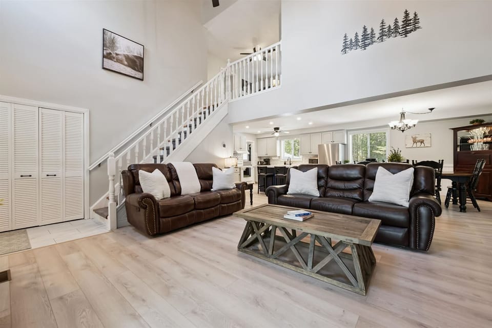 Open-concept living space with comfortable furnishings and plenty of natural light throughout the cottage.