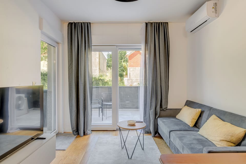 Comfort Apartment, Balcony | Living area | 75-cm Smart TV with satellite channels