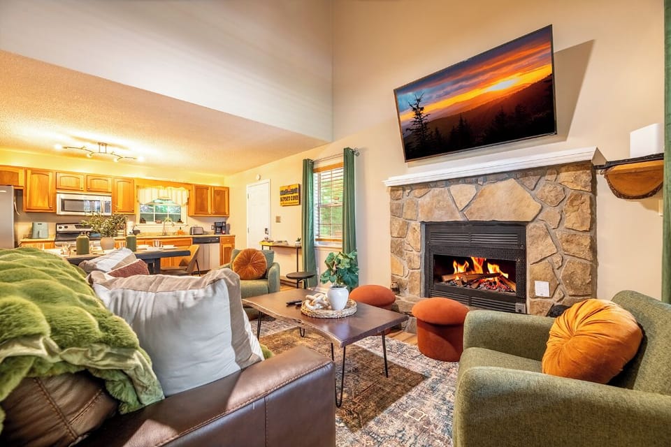 Gather around the stone fireplace in this welcoming living space, where plush seating set the scene for your cozy retreat moments together.