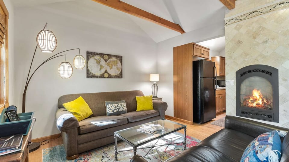 Cozy living room with two sofas, smart TV and gas fireplace.
