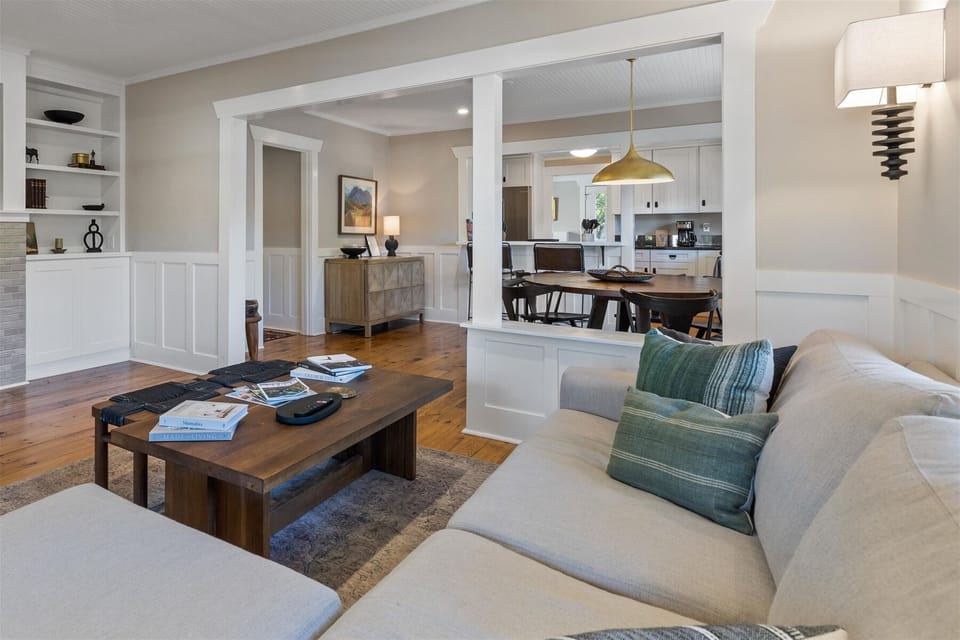 Living room with a fireplace and 55" smart TV with Sonos wireless sound system.