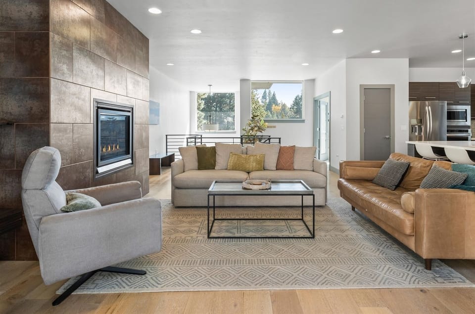 Living room with smart TV and gas fireplace - Cozy up in style! This living room is perfect for relaxation and gathering, with direct views of the backyard.