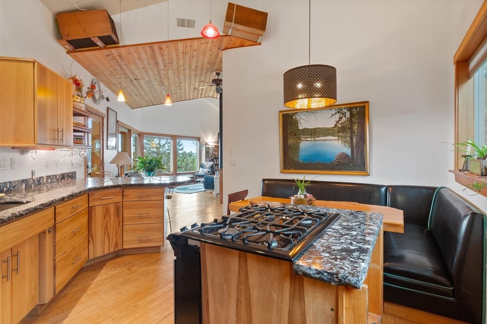 Gas range, kitchen nook with bench seating.