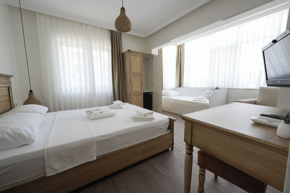 Superior Triple Room, Garden View | Minibar, desk, laptop workspace, free WiFi