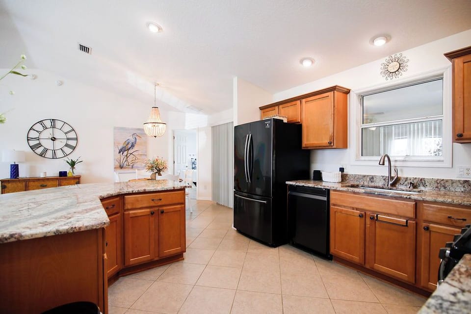 Your fully equipped kitchen features granite counters, modern appliances, and a spacious island—perfect for preparing meals and gathering with loved ones in this bright, inviting space.