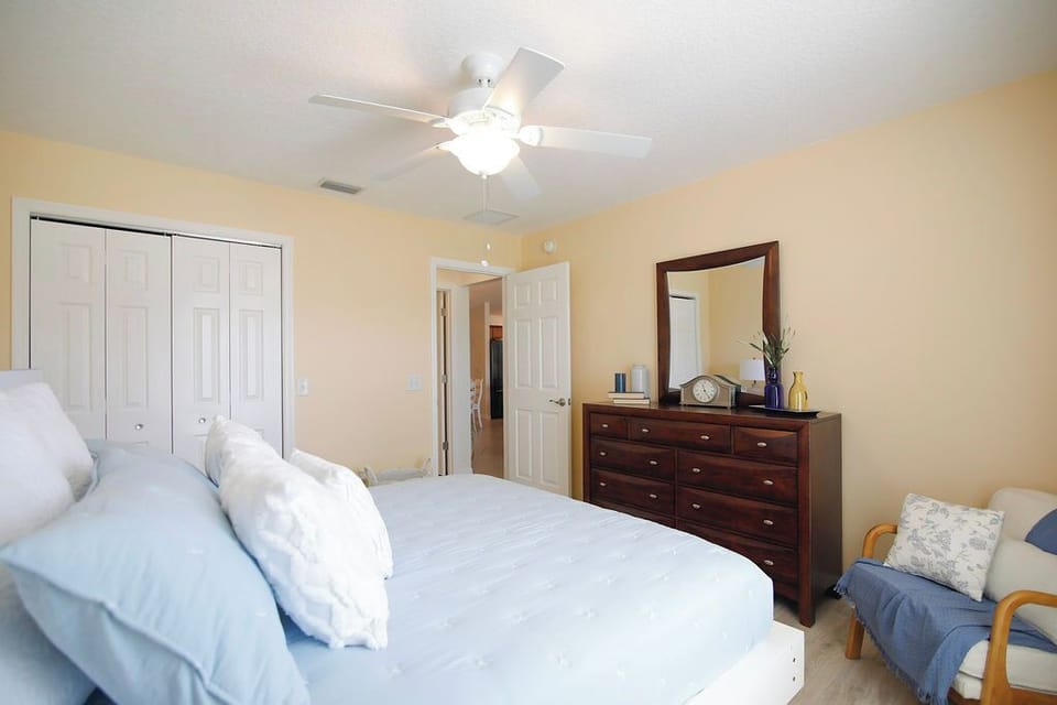 Unwind in your peaceful bedroom, complete with plush bedding, a gentle ceiling fan, and ample closet space for settling in.