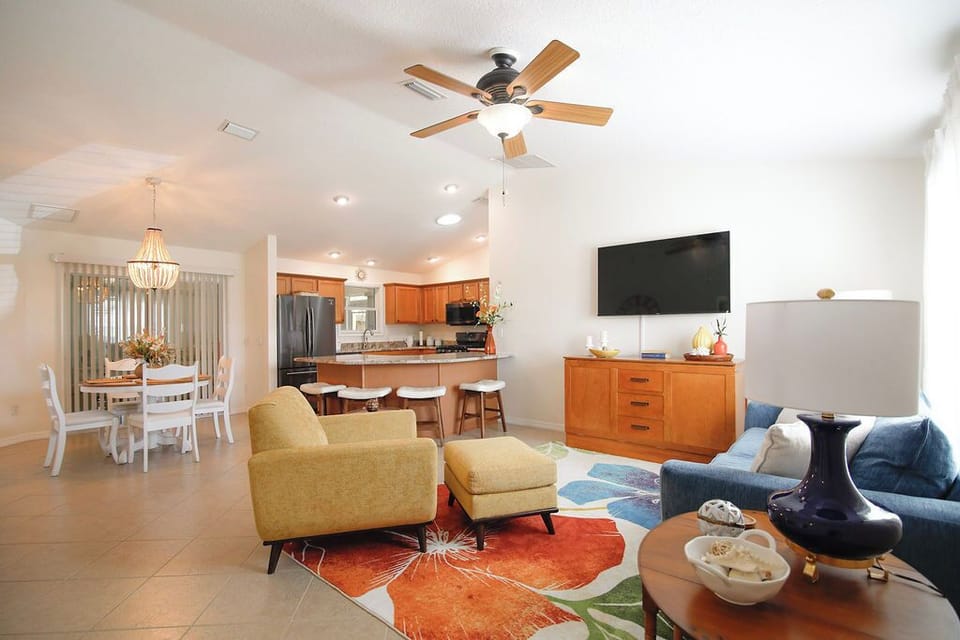 Settle into your spacious open-concept living area, where warm wood tones, cozy seating, and a fully equipped kitchen invite you to relax and feel right at home.
