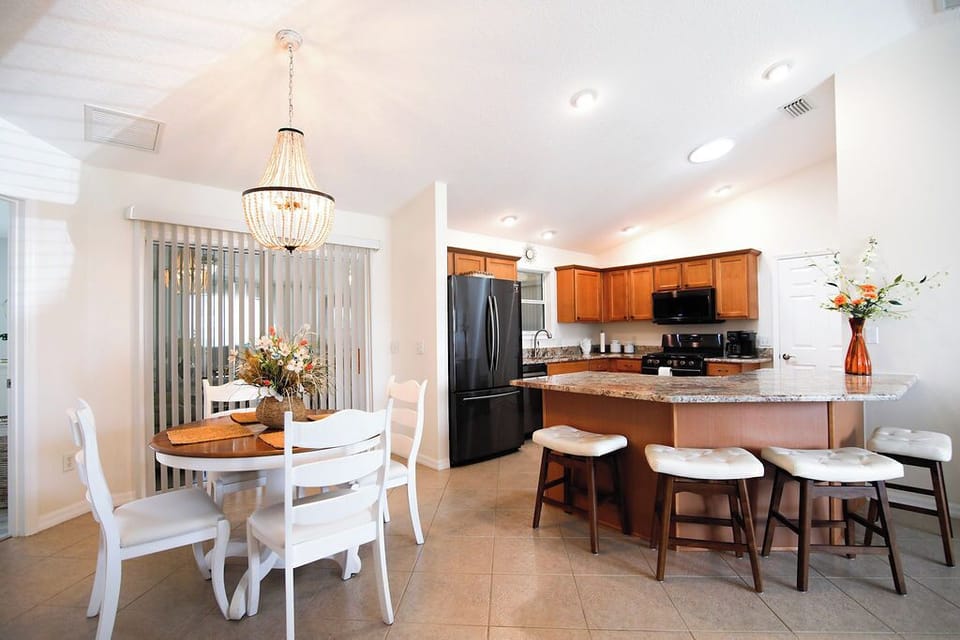 Picture yourself preparing meals in this bright, open kitchen with granite counters and modern appliances, then gathering at the breakfast bar or dining table with loved ones for unforgettable conversations and laughter.