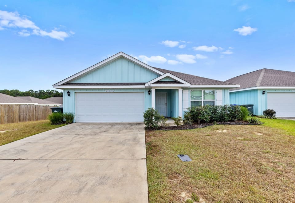 Front view of the home with tidy landscaping and plenty of parking.