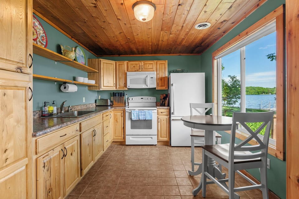 You'll love preparing meals in this bright kitchen with stunning lake views just outside your door. Warm wood details and modern appliances make cooking a pleasure.
