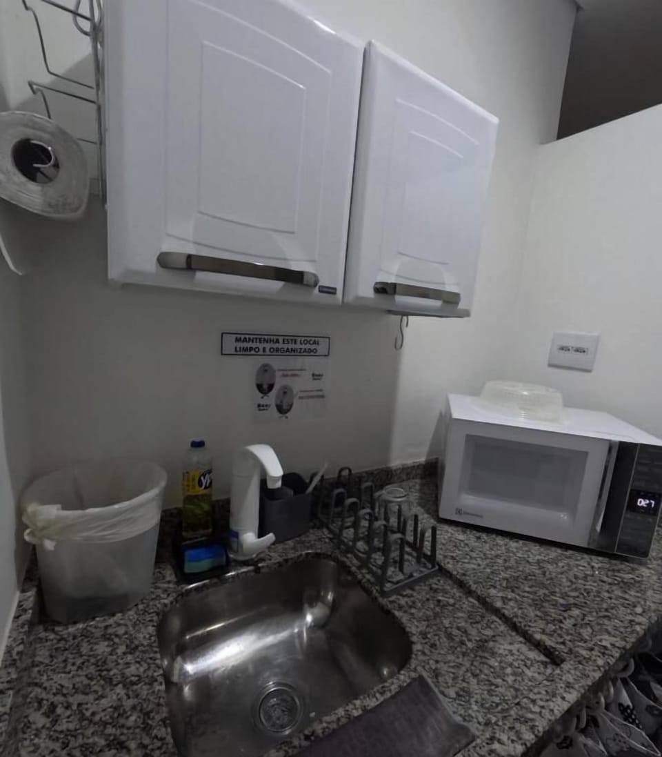 Fridge, microwave, cleaning supplies, paper towels