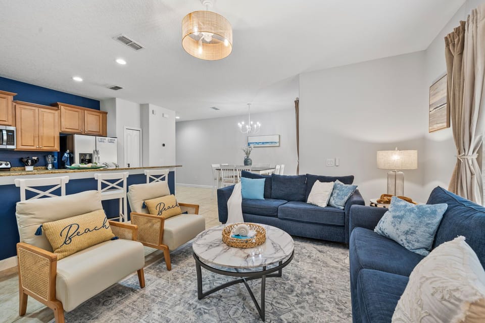 Spacious gathering space featuring multiple sofas, a coffee table, and more.