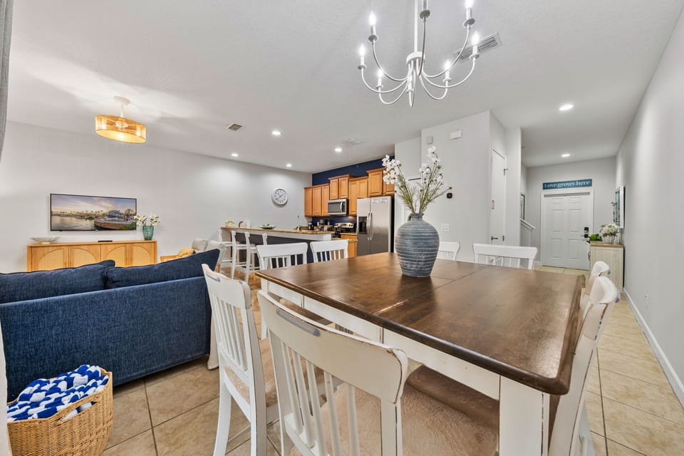 Dining table positioned beside the open-concept living and kitchen areas.