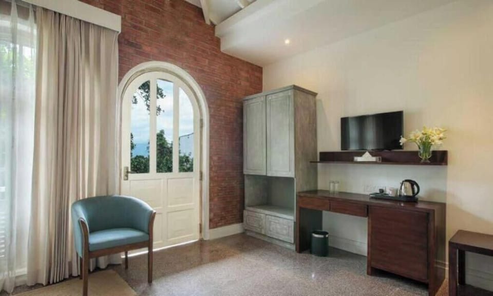 Deluxe Double Room, Balcony, Garden View | Living area | TV