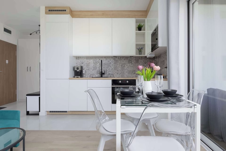Modern studio kitchen with dining table and open living space
