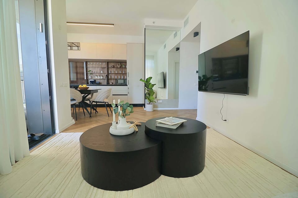 Modern kitchen workspace with espresso setup and glassware, perfect for preparing drinks before exploring the neighborhood.