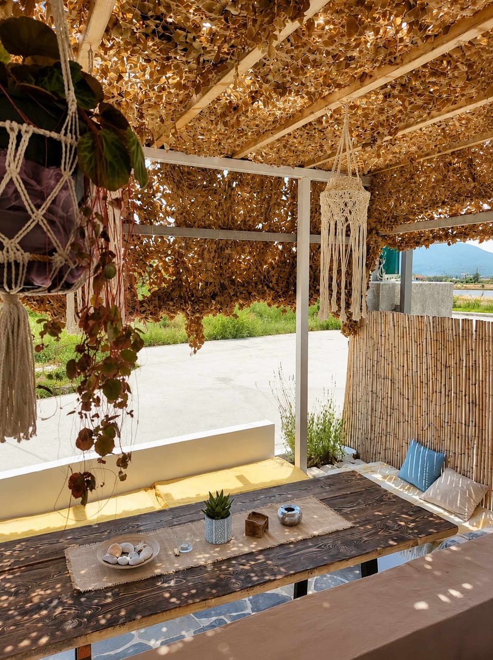 Traditional reed roofing and natural textures create a relaxed island atmosphere that complements the outdoor living experience.