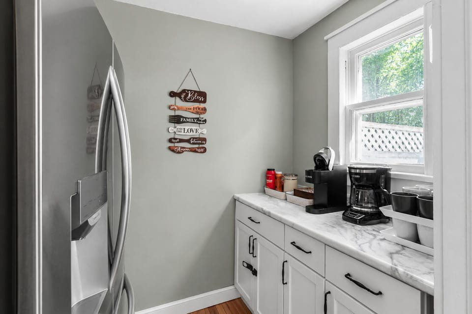 Bright kitchen coffee station with natural light and modern finishes