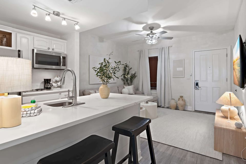 Kitchen: Bar seating, stovetop, microwave, refrigerator, drip coffee maker, cookware & dinnerware