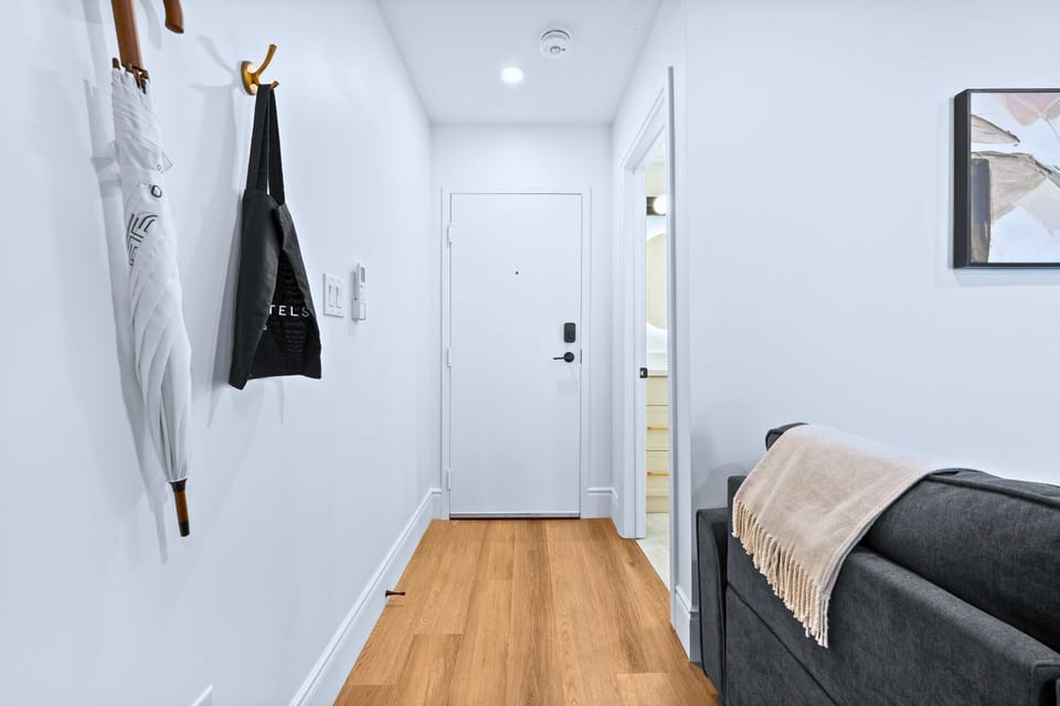 The house hallway features a tote and an umbrella for added convenience.