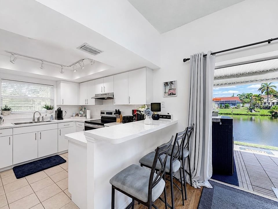 Perfect indoor-outdoor living from the fully equipped kitchen to the lake views.