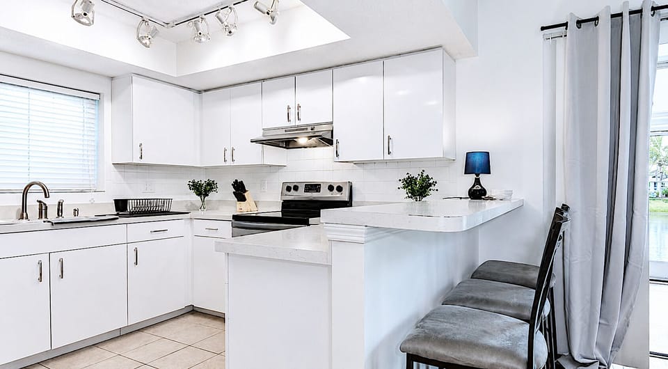 Bright open kitchen with a spacious breakfast bar to keep everyone connected.