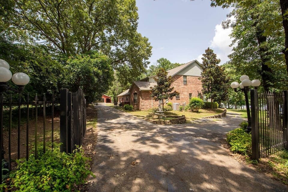 All roads around house private and lead to boat house and boat ramp. Red car garage for guest use.