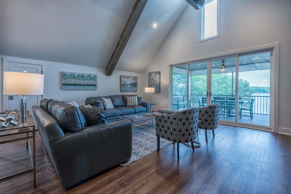 Living room with lots of seating options and access to screened porch.