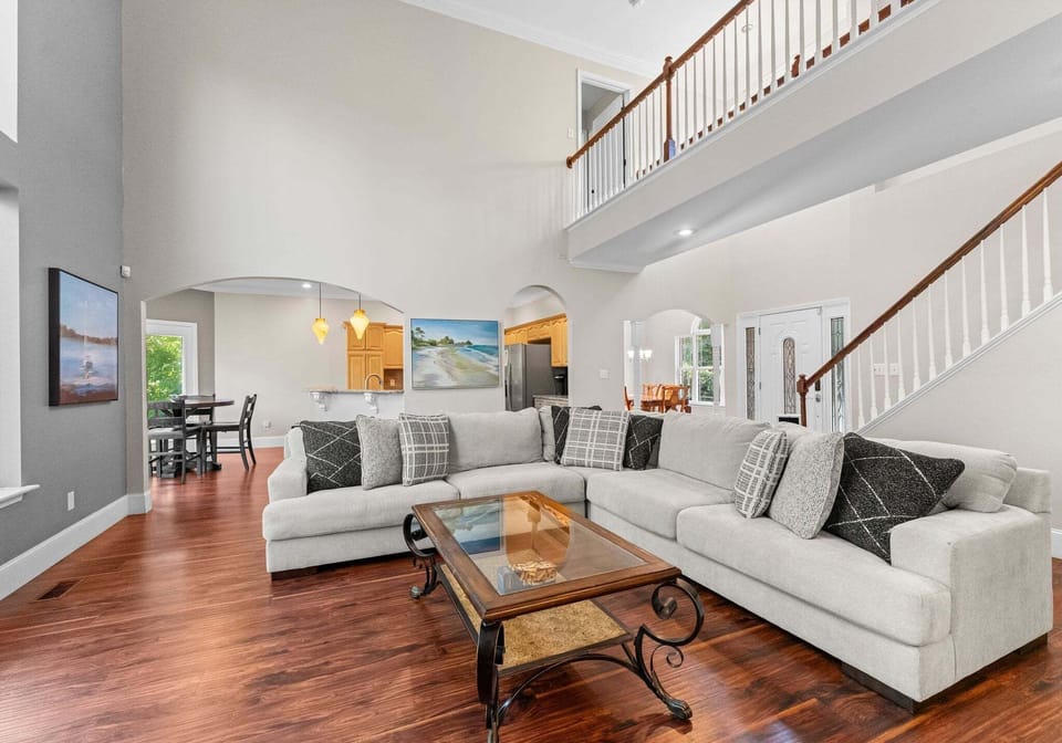 Living room area with sectional. and TV.