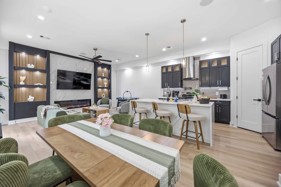Open-concept living with chef’s kitchen, fireplace, and stylish dinner seating